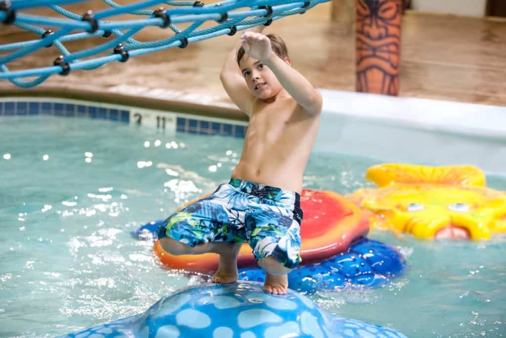 A child enjoys playing the pool.