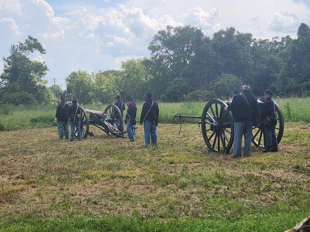 Volunteers reenact the use of cannons in battle.